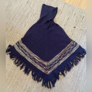 Knit Acrylic hooded cape/poncho with fringe hem. Blue, green, maroon and white.